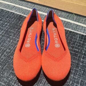Orange Rothy’s with navy and white heel stripes, GUC